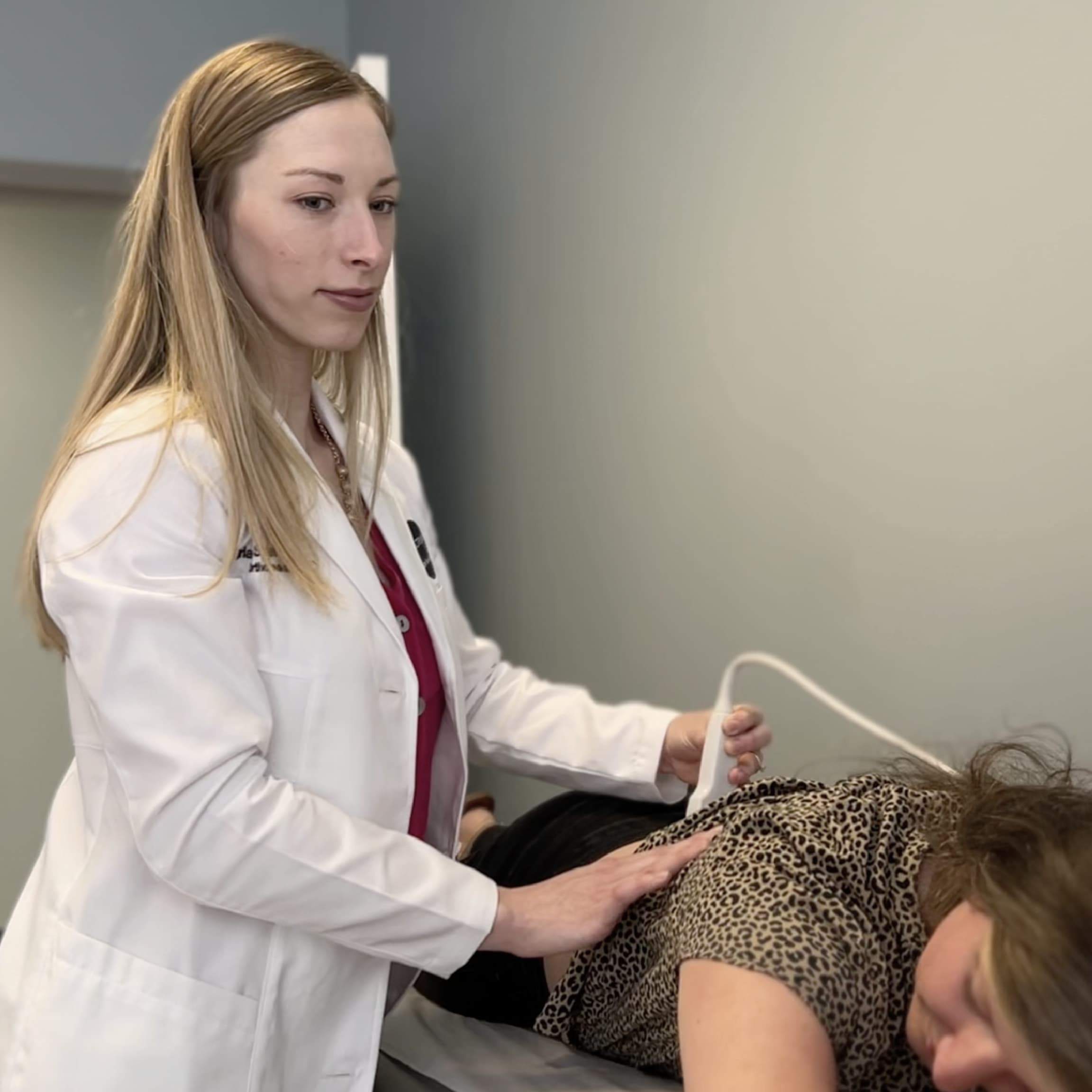 Chiropractor using handheld device during treatment